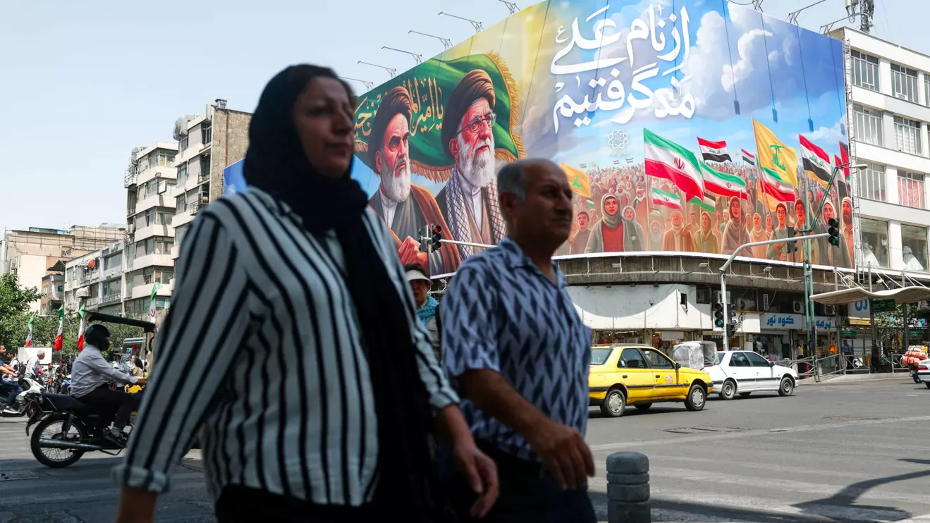 People walk past a billboard depicting the late leader of the Islamic Revolution, Ayatollah Ruhollah Khomeini, and the late Iran's Supreme Leader Ayatollah Ali Khamenei, on a street in Tehran, Iran June 6, 2026. Majid Asgaripour/WANA (West Asia News Agency) via Reuters