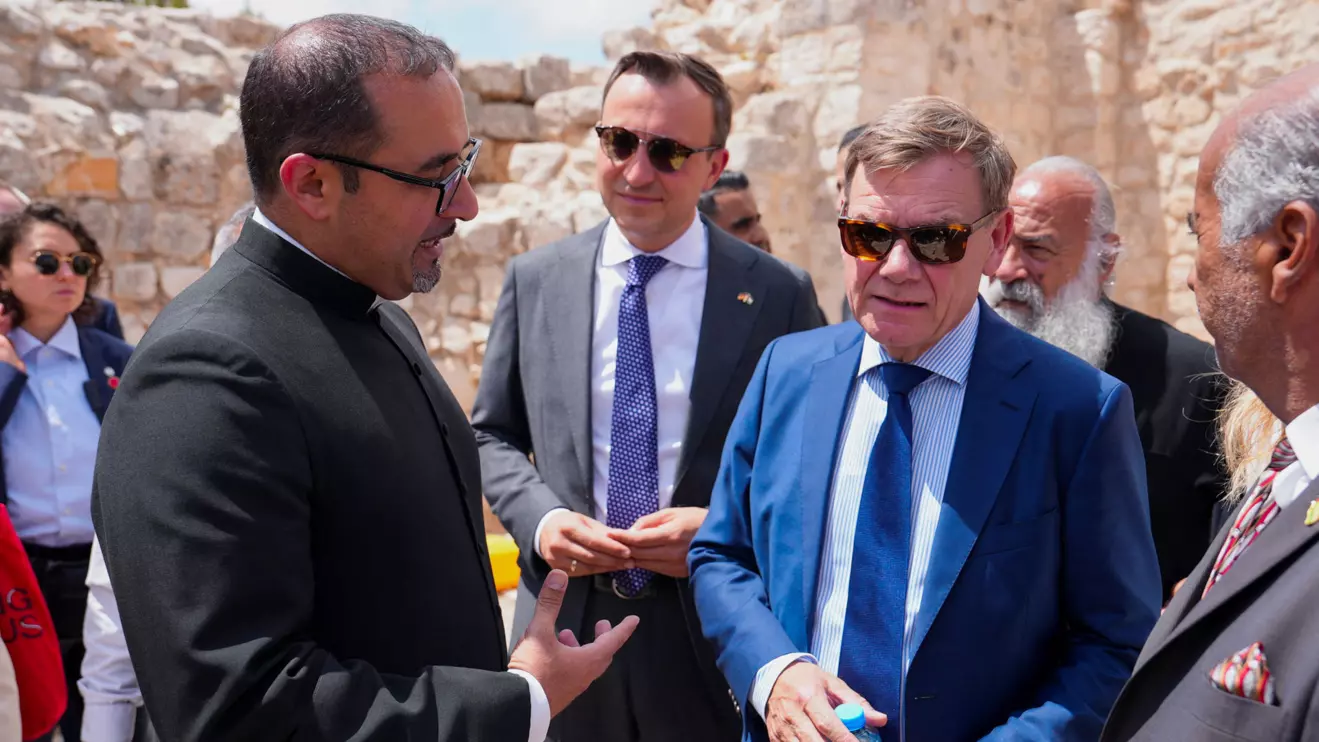 Germany's Foreign Minister Johann Wadephul listens a member of clergy during the visit to the town of Taybeh, a Christian village in the Israeli-occupied West Bank, following settler attacks, August 1, 2025. Reuters/Ali Sawafta