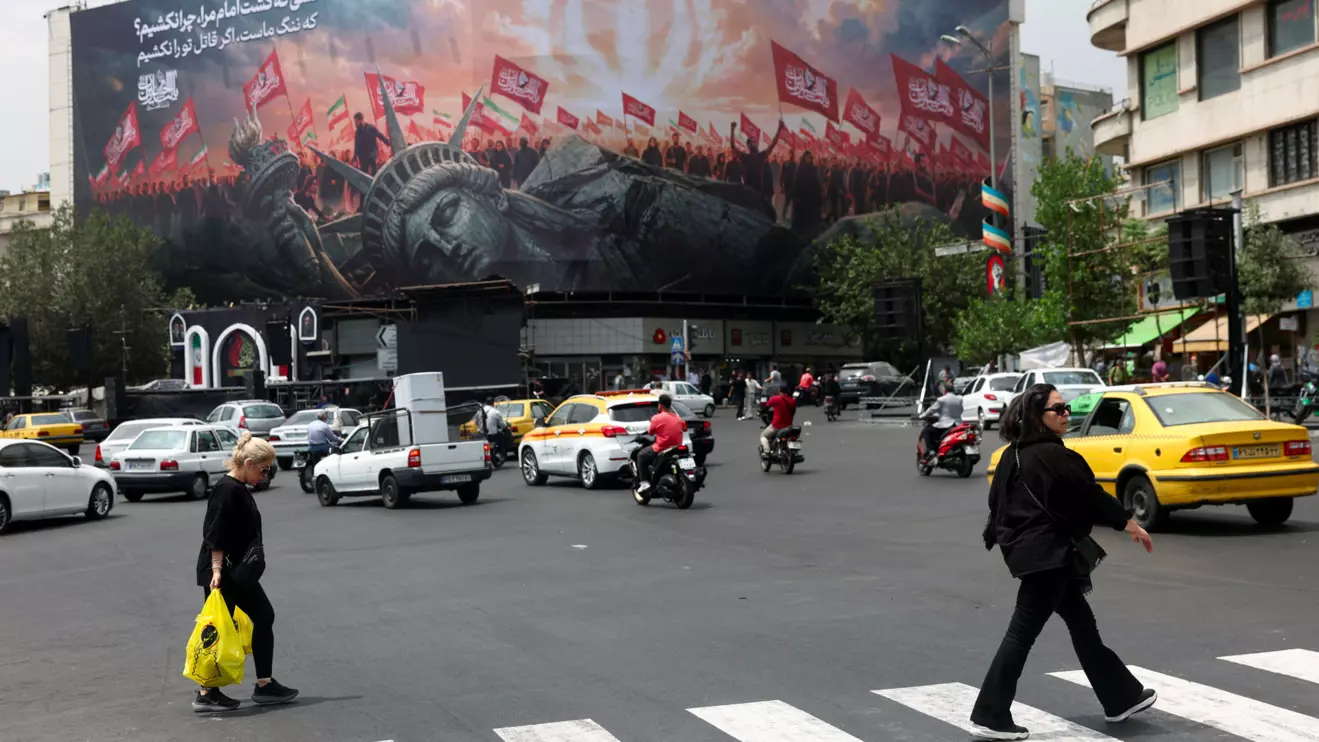 People walk past an anti-U.S. billboard on a street in Tehran, Iran, August 3, 2026. Majid Asgaripour/WANA (West Asia News Agency) via Reuters