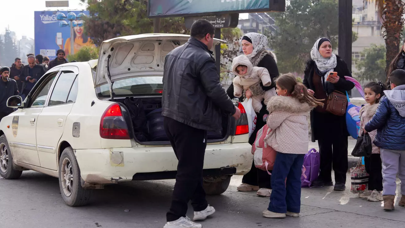 A group of civilians carry bags and belongings as they flee following renewed clashes between the Syrian army and the Syrian Democratic Forces (SDF), in Aleppo, Syria, January 7, 2026. Reuters/Karam al-Masri