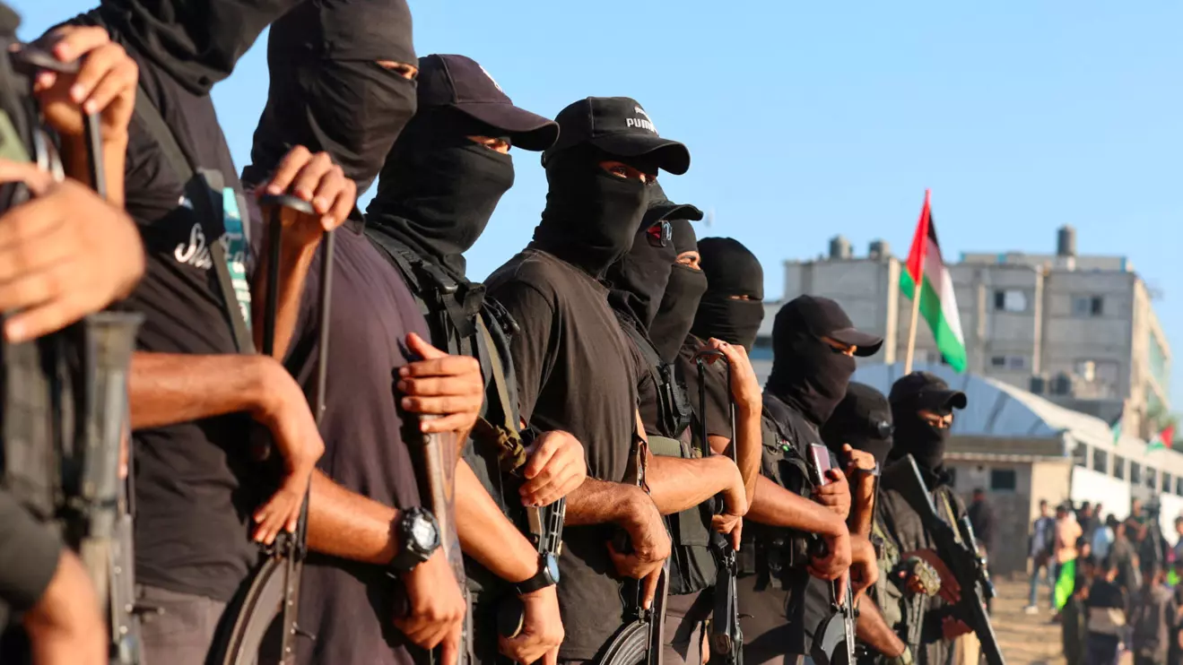 Palestinian militants stand guard on the day that hostages held in Gaza since the deadly October 7, 2023 attack, are handed over to the International Committee of the Red Cross (ICRC), as part of a ceasefire and hostages-prisoners swap deal between Hamas and Israel, in Khan Younis, southern Gaza Strip, October 13, 2025. Reuters/Ramadan Abed