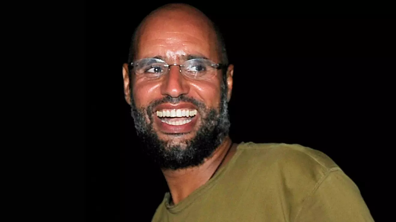 Saif al-Islam, the son of Libyan leader Muammar Gaddafi, smiles as he greets supporters in Tripoli in this August 23, 2011 file photo. Reuters/Paul Hackett