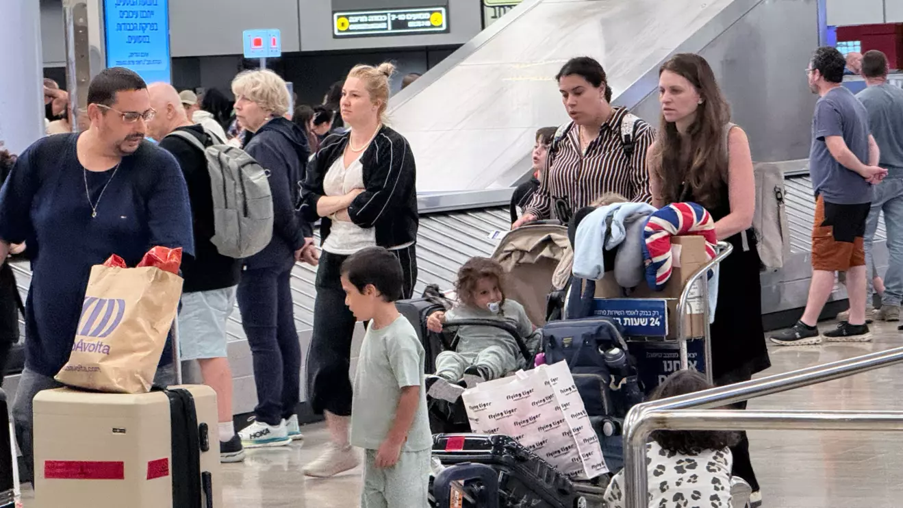 Frustrated travelers wait for delayed baggage at Ben Gurion Airport near Tel Aviv on Monday © Mena Today 