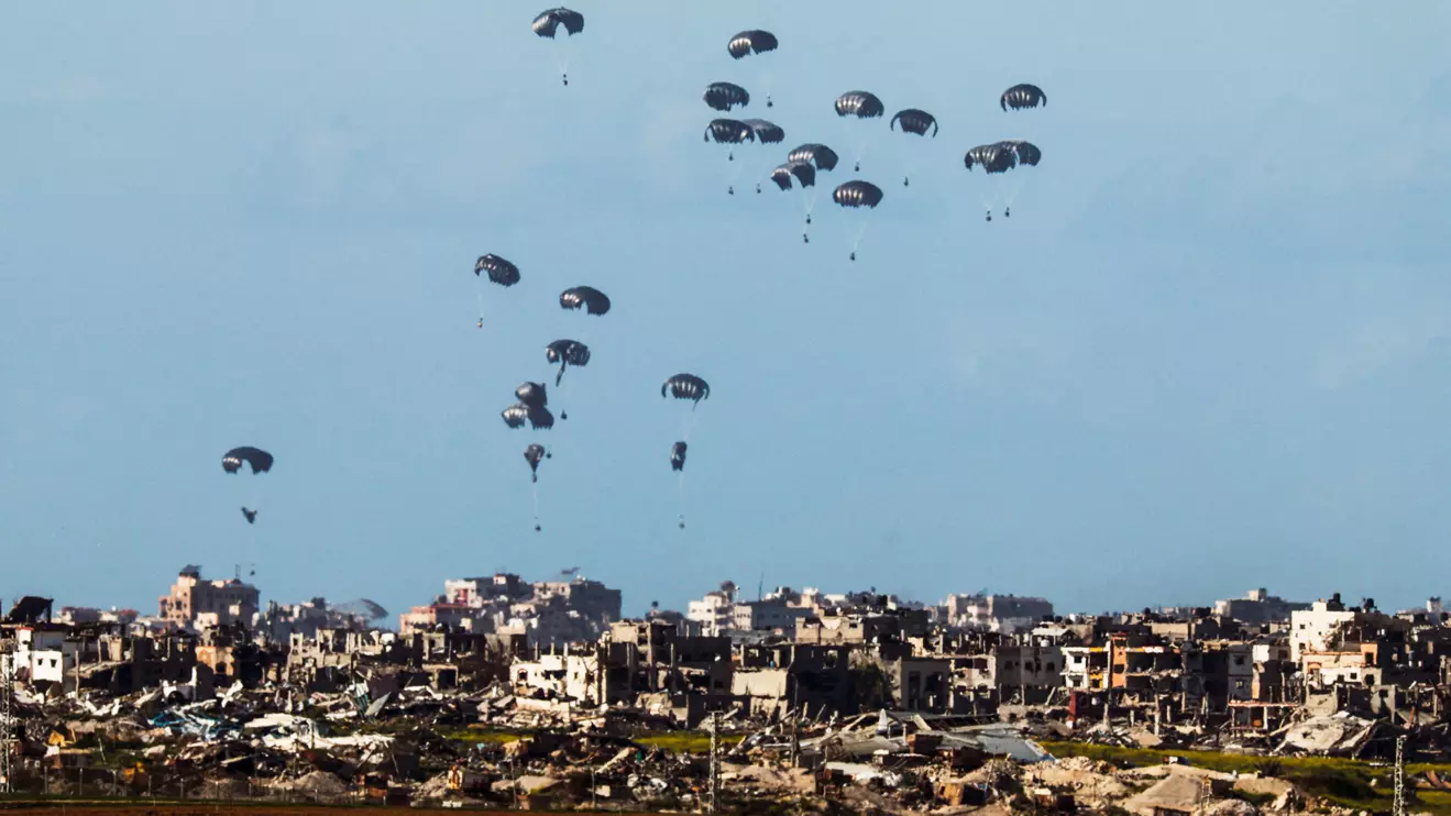 Packages fall towards northern Gaza, after being dropped from a military aircraft, amid the ongoing conflict between Israel and the Palestinian group Hamas, as seen from Israel's border with Gaza in southern Israel March 7, 2024. Reuters/Amir Cohen