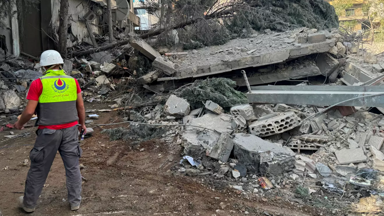 A civil defence member of the Islamic Health Authority (Hezbollah) walks at a site damaged in an Israeli strike in Nabatieh, southern Lebanon October 16, 2024. Reuters/Ali Hankir
