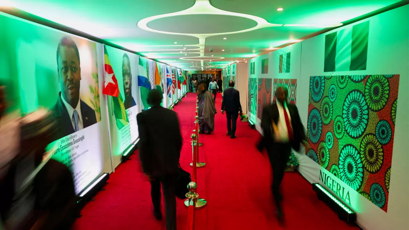People walk into the Eko Conventional Hall where leaders from the Economic Community of West African States (ECOWAS) will gather to celebrate the golden jubilee of the regional bloc in Nigeria's commercial capital, Lagos, Nigeria, May 28, 2025. Picture taken using slow shutter speed. Reuters/Sodiq Adelakun