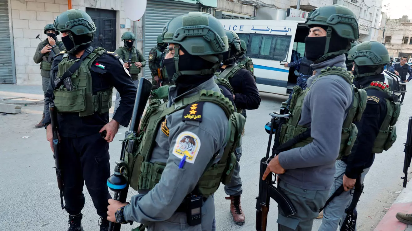 Palestinian security forces stand as Palestinian demonstrators call for an end to clashes between Palestinian security forces and militants in Jenin, in the Israeli-occupied West Bank, December 16, 2024. Reuters/Raneen Sawafta
