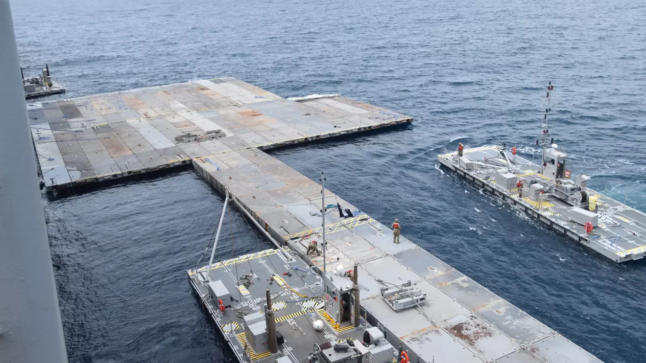 U.S. Army Soldiers assigned to the 7th Transportation Brigade (Expeditionary) and U.S. Navy sailors attached to the MV Roy P. Benavidez assemble the Roll-On, Roll-Off Distribution Facility (RRDF), or floating pier, to assist in the delivery of humanitarian aid to the people of Gaza, in the Mediterranean Sea April 26, 2024. U.S. Army Central/Handout via Reuters