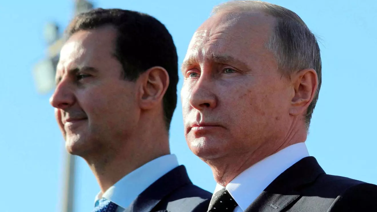 Russian President Vladimir Putin (R) and Syrian President Bashar al-Assad visit the Hmeymim air base in Latakia Province, Syria December 11, 2017. Mikhail Klimentyev/ via Reuters