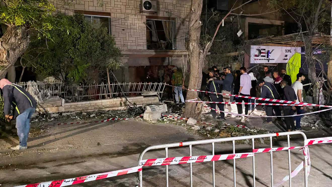 People stand at the site of an Israeli airstrike that targeted a residential building in the Mezzah suburb in western Damascus, according to Syrian state media, Syria October 2, 2024. Reuters/Firas Makdesi