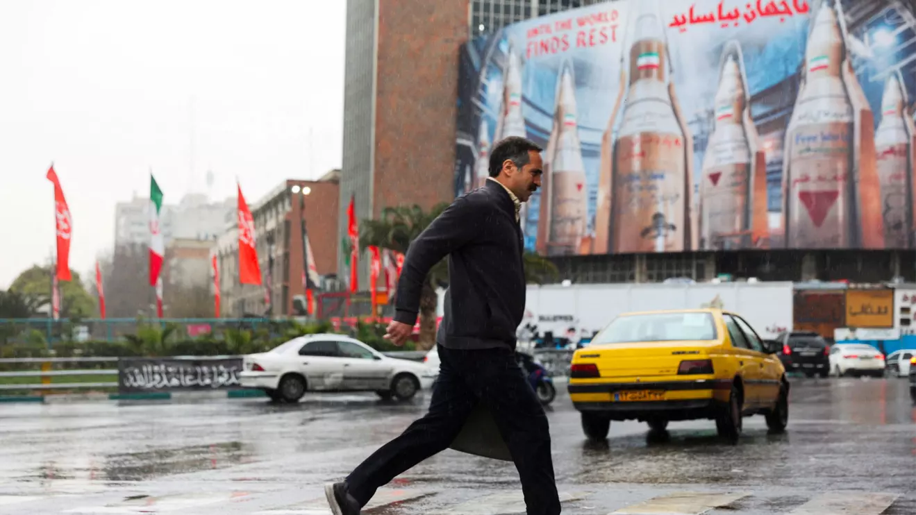 A man moves past a huge billboard displaying images of Iranian missiles, amid the US-Israeli conflict with Iran, in Tehran, Iran, March 16, 2026. Majid Asgaripour/WANA (West Asia News Agency) via Reuters