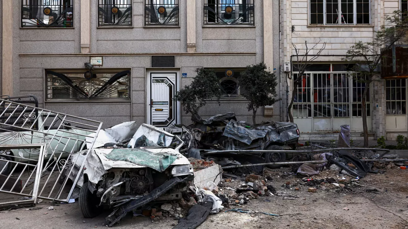 Car wrecks and a residential building damaged by a strike amid the U.S.-Israeli conflict with Iran, in Tehran, Iran, March 30, 2026. Majid Asgaripour/WANA (West Asia News Agency) via Reuters
