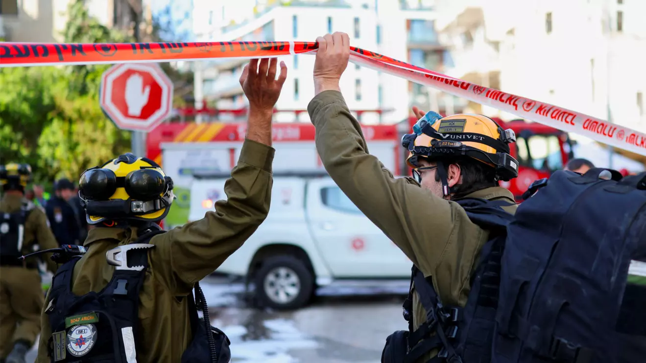 Emergency personnel work at the site following Iranian missile barrages in central Israel, amid the U.S.-Israel conflict with Iran, in Tel Aviv, Israel, March 24, 2026. Reuters/Ronen Zvulun