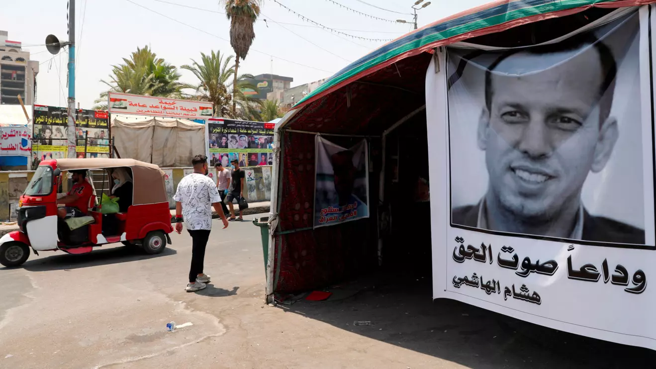 A poster depicting the former government advisor and political analyst Hisham al-Hashemi, who was killed by gunmen is seen at the Tahrir Square in Baghdad, Iraq July 8, 2020. REUTERS/Thaier al-Sudani