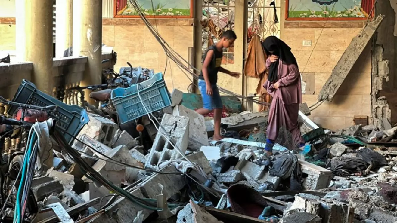 Palestinians inspect the site of an Israeli strike on a school sheltering displaced people, amid the Israel-Hamas conflict, in Gaza City, August 10, 2024. Reuters/Abed Sabah
