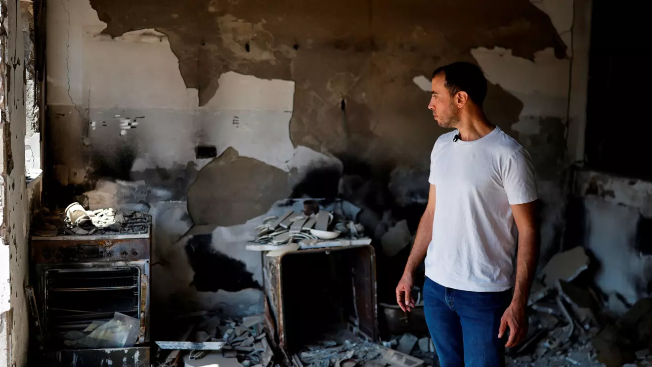 Tal Shoham, a former hostage who was kidnapped by Hamas on October 7, 2023, with his wife and two children as well as three other members of his family, and held in Gaza for 505 days, looks at the damage to the home of his in-laws in Kibbutz Beeri, southern Israel, September 15, 2025. Reuters/Amir Cohen