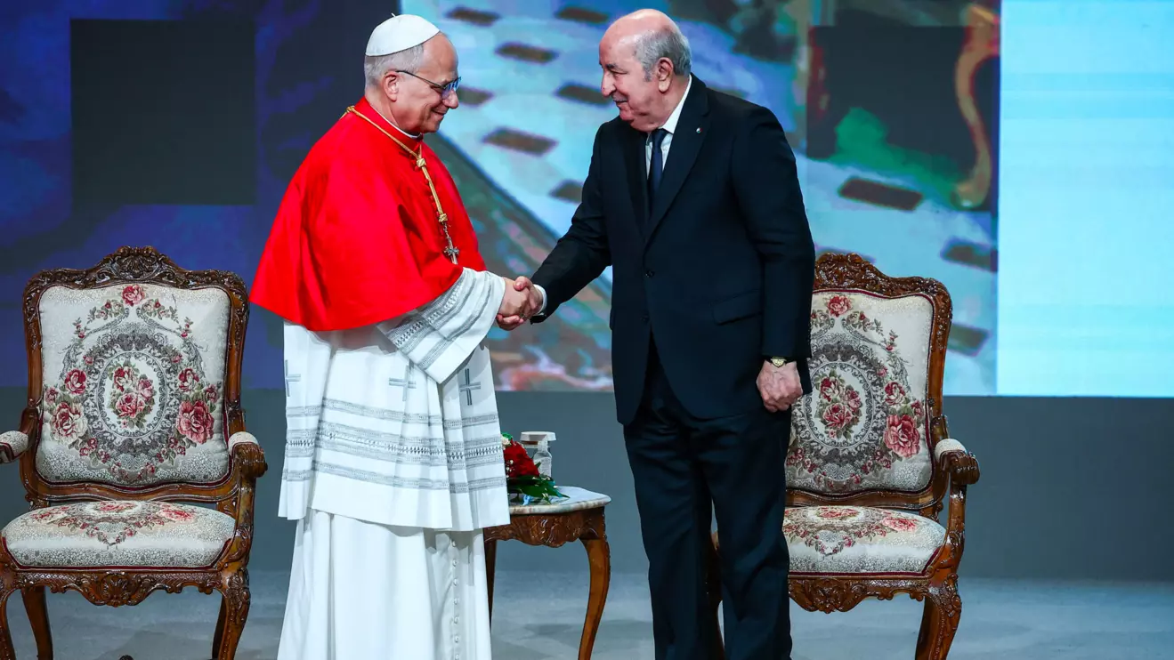 Pope Leo XIV and Algerian President Abdelmadjid Tebboune shakes hands at a meeting with the authorities, civil society and the diplomatic corps, at the cultural centre of the Great Mosque Of Algiers (Djamaa El Djazair), after Pope Leo XIV was criticized by U.S. President Donald Trump, in Mohamadia, Algiers, Algeria, April 13, 2026. Reuters/Guglielmo Mangiapane