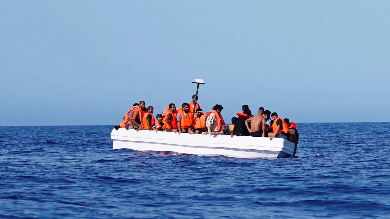 Migrants on a fiberglass boat wait to be assisted by NGO Open Arms rescue boat "Astral" in international waters south of Lampedusa, in the Mediterranean Sea, July 24, 2025. Reuters/Ana Beltran