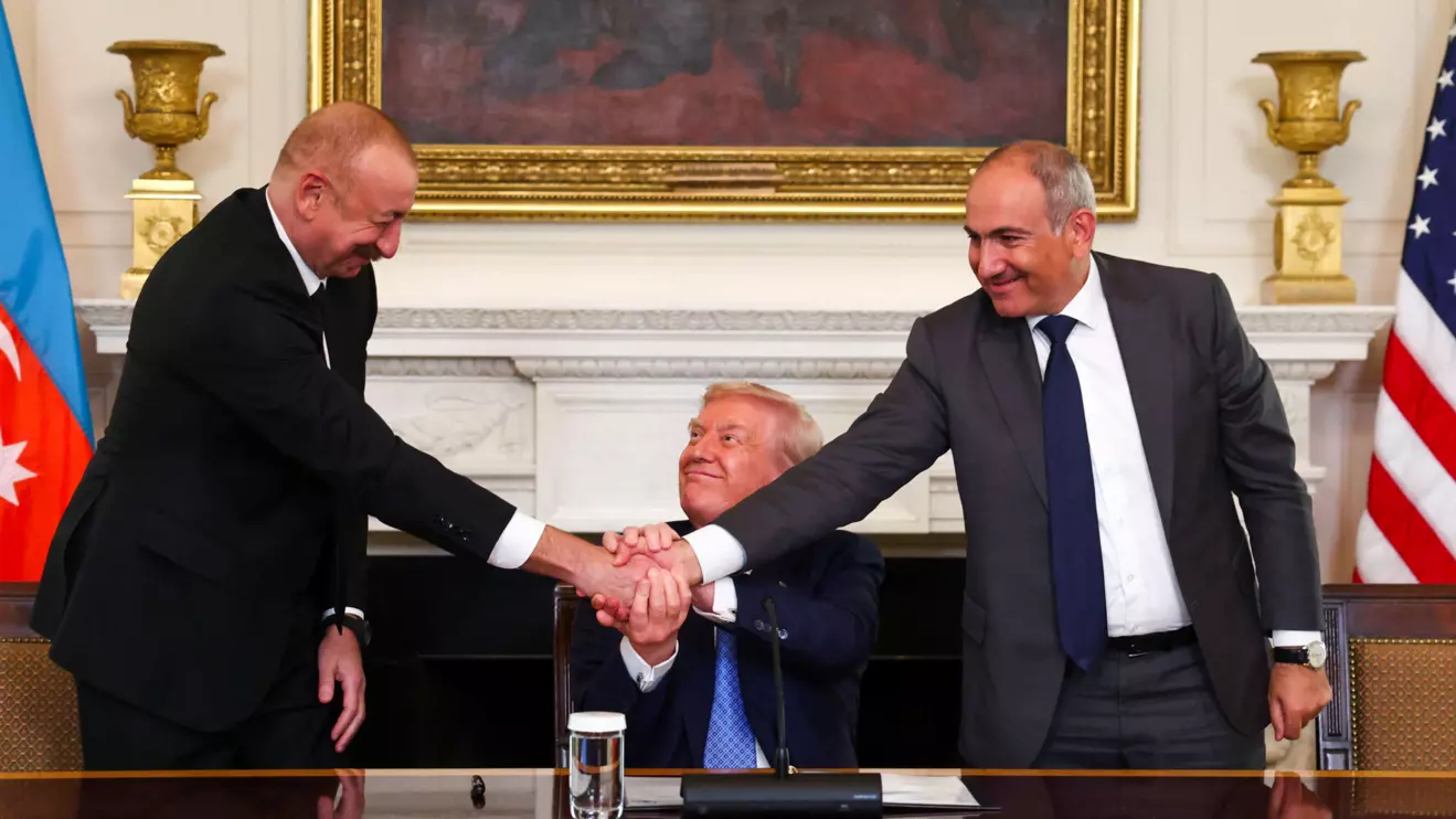 U.S. President Donald Trump holds the hands of Azerbaijan's President Ilham Aliyev and Armenia's Prime Minister Nikol Pashinyan as they shake hands between each other during a trilateral signing event, at the White House, in Washington, D.C., August 8, 2025. Reuters/Kevin Lamarque