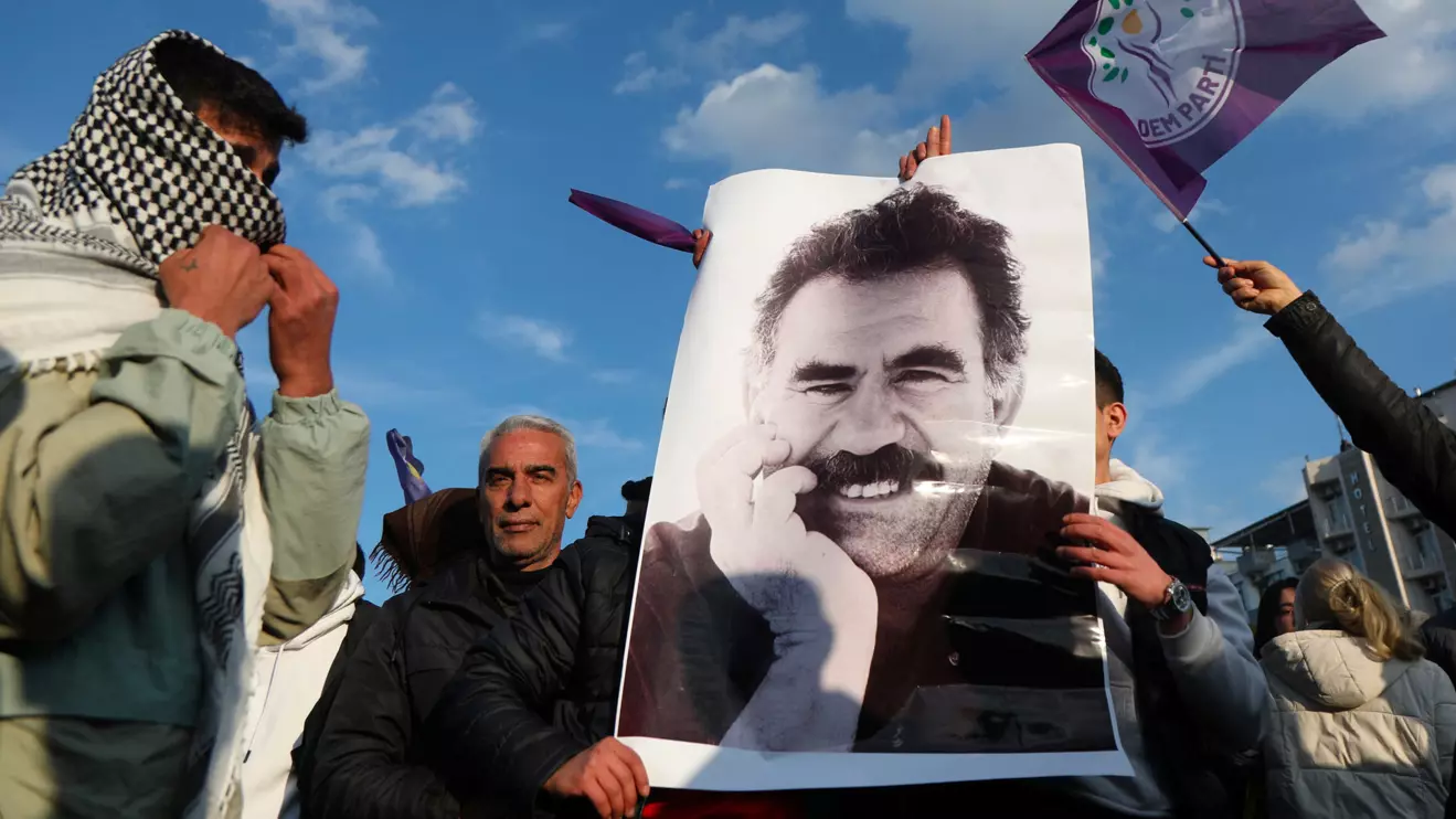 A demonstrator holds a picture of jailed Kurdish militant leader Abdullah Ocalan during a rally in Diyarbakir, Turkey, February 27, 2025. Reuters/Sertac Kayar