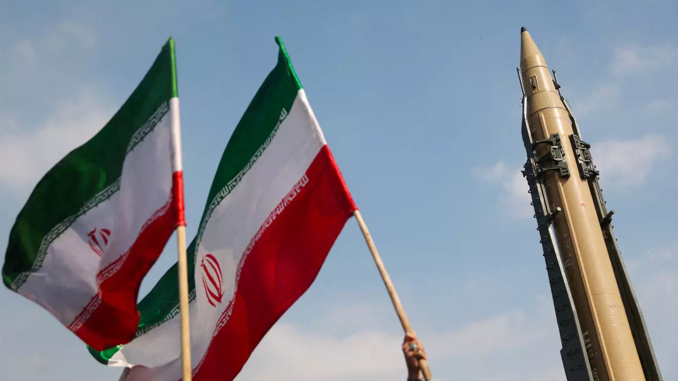 People wave flags next to an Iranian missile on display during the 46th anniversary of the Islamic Revolution in Tehran, Iran, February 10, 2025. Majid Asgaripour/WANA (West Asia News Agency) via Reuters