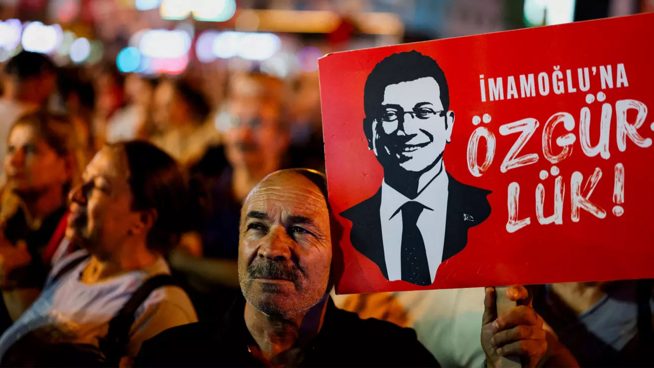 A man holds up a sign featuring an image of Istanbul Mayor Ekrem Imamoglu during a rally to protest against a recent court ruling that ousted the main opposition Republican People's Party's (CHP) Istanbul provincial leadership, in Istanbul, Turkey, September 10, 2025. Reuters/Umit Bektas