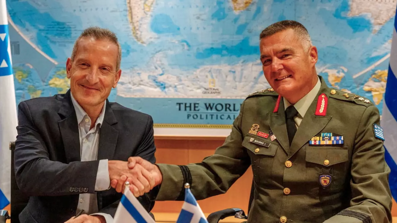 Director General of the Israel Ministry of Defense (IMOD), Maj. Gen. (Res.) Amir Baram, and his Greek counterpart, Ioannis Bouras, shake hands as they signed an approximately €3 billion defense export agreement in a ceremony at the IMOD's headquarters in Tel Aviv © Israel Defence Ministry