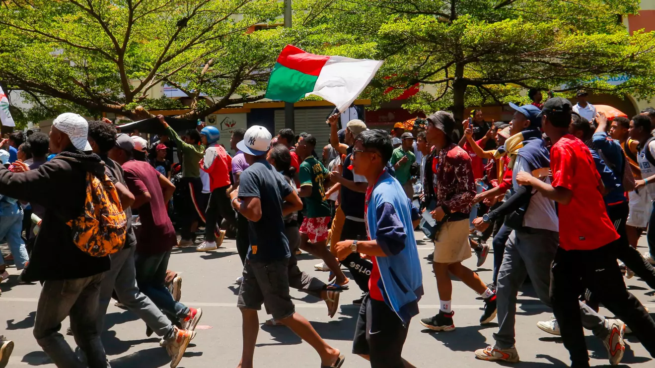 Protesters hold the Malagasy flag as they run during a nationwide youth-led demonstration over frequent power outages and water shortages, along the Independence Avenue in Antananarivo, Madagascar, October 13, 2025. Reuters/Zo Andrianjafy