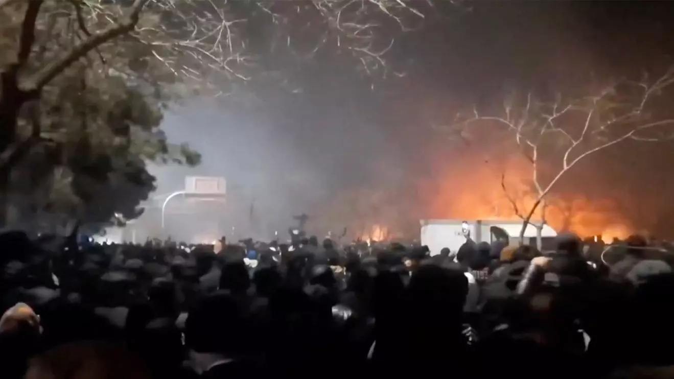Smoke rises as protesters gather amid evolving anti-government unrest at Vakilabad highway in Mashhad, Razavi Khorasan province, Iran, released on January 10, 2026, in this screen grab obtained from a social media video