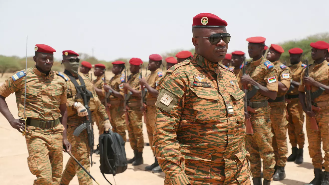 Burkina Faso President Lieutenant Colonel Paul-Henri Damiba is welcomed by soldiers in Dori, Sahel region as he arrives to motivate his troops, after armed men killed civilians and militaries in Seytenga, at an airport in Dori, Burkina Faso June 15, 2022. Burkina Faso's Presidential Press Service/Handout via Reuters 