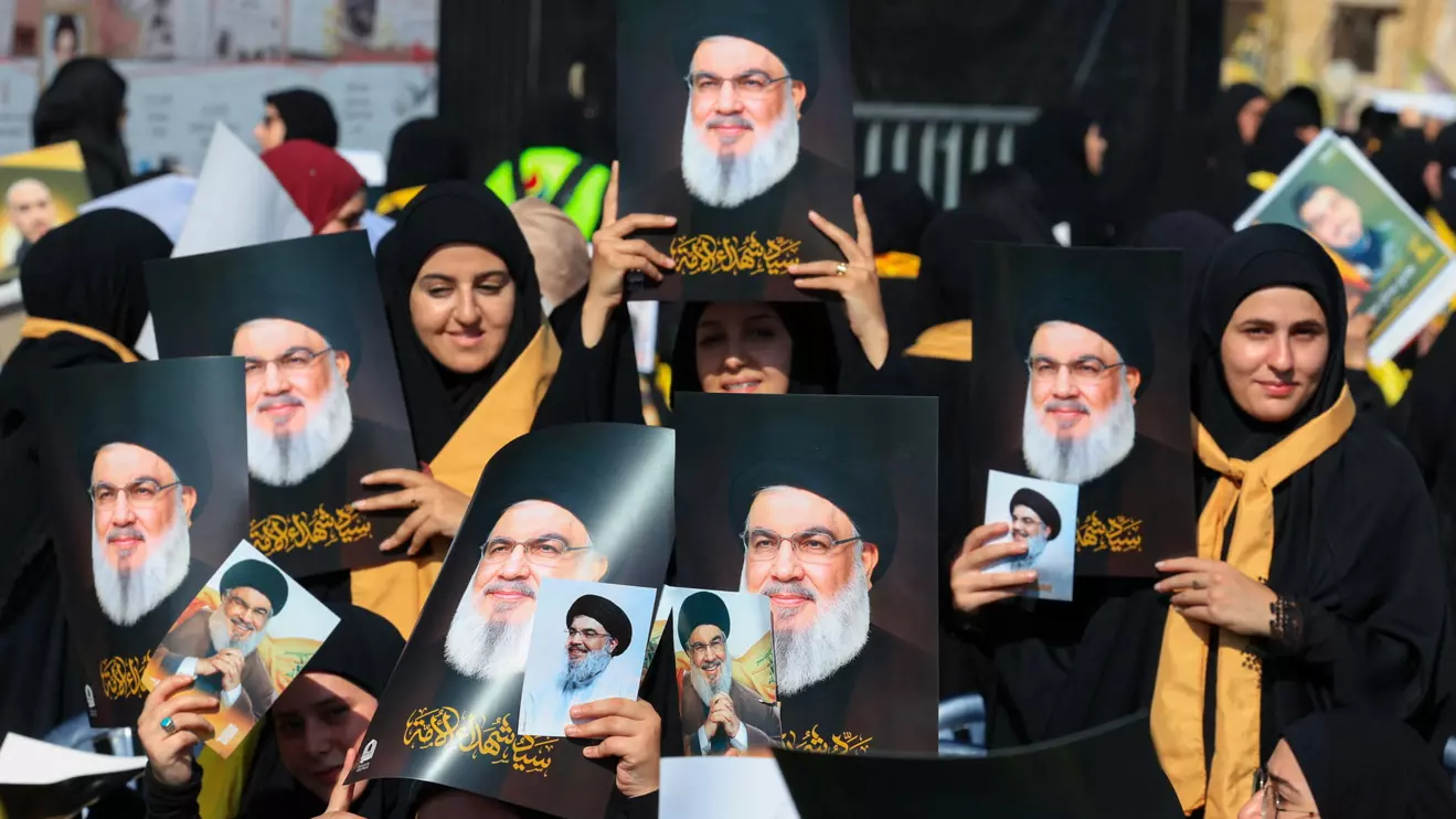 Hezbollah supporters hold images of late Hezbollah leader Hassan Nasrallah at a ceremony held by Hezbollah to commemorate the first anniversary of Nasrallah's killing by Israel, on the outskirts of Beirut, Lebanon, September 27, 2025. Reuters/Mohamed Azakir