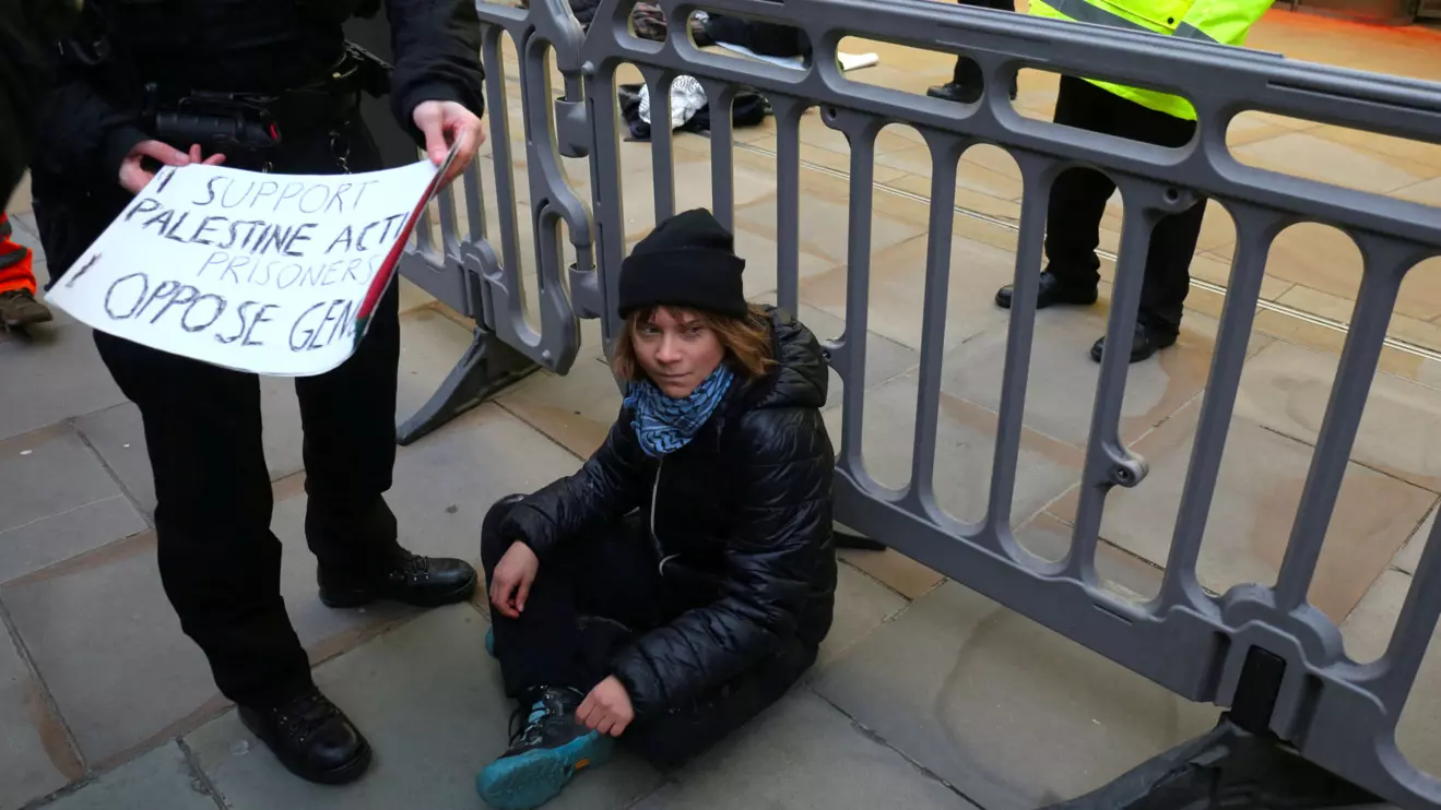 A police officer takes away a sign that Swedish activist Greta Thunberg was holding during a pro-Palestinian protest that says she supports prisoners linked to Palestine Action, an organisation which the British government has proscribed as a terrorist group, in London, Britain, December 23, 2025, Reuters