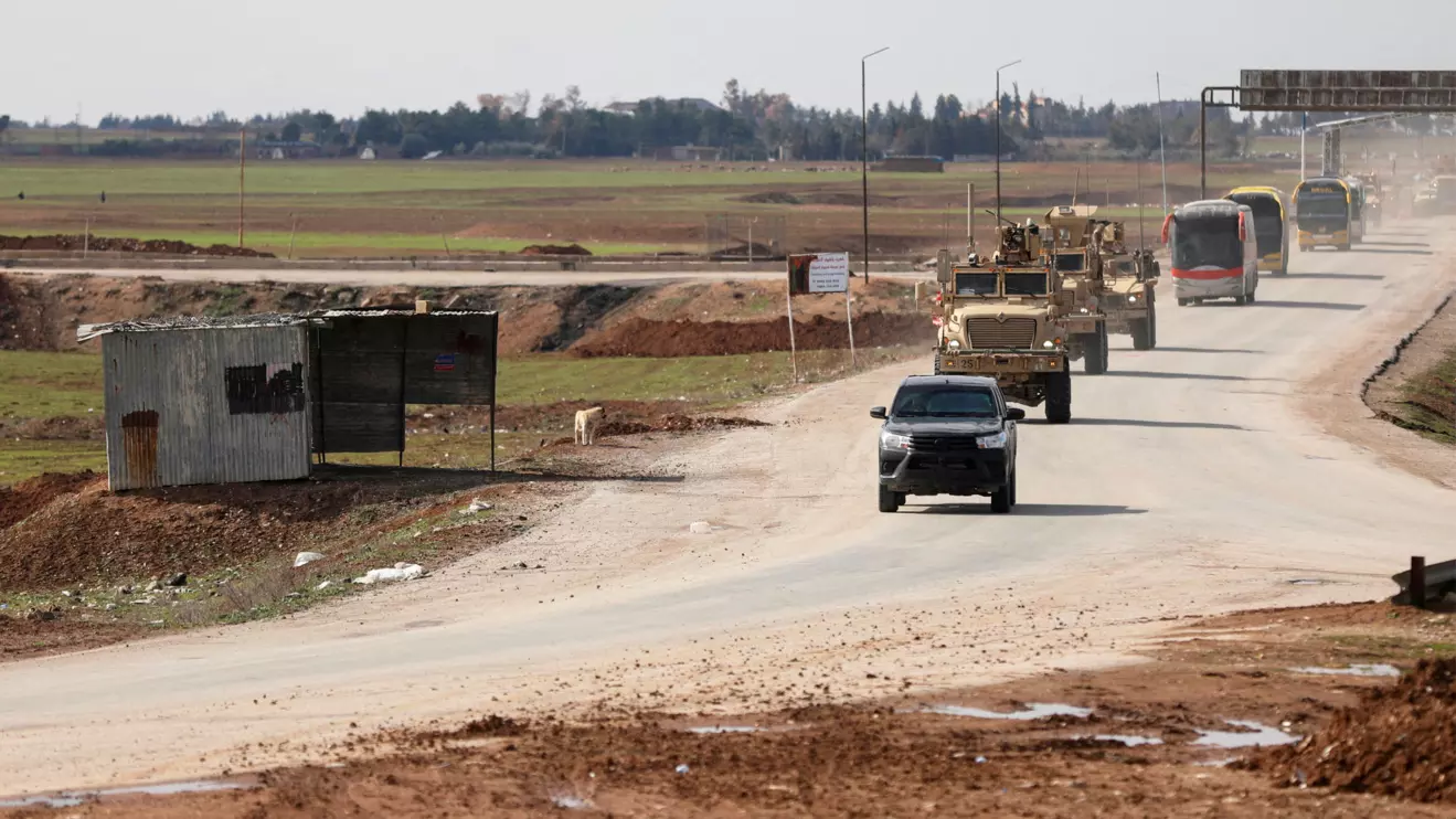 U.S. military vehicles move ahead of buses transporting Islamic State detainees from Syria to Iraq, according to a security source from the Syrian Democratic Forces, in Qamishli, Syria, February 8, 2026. Reuters/Orhan Qereman