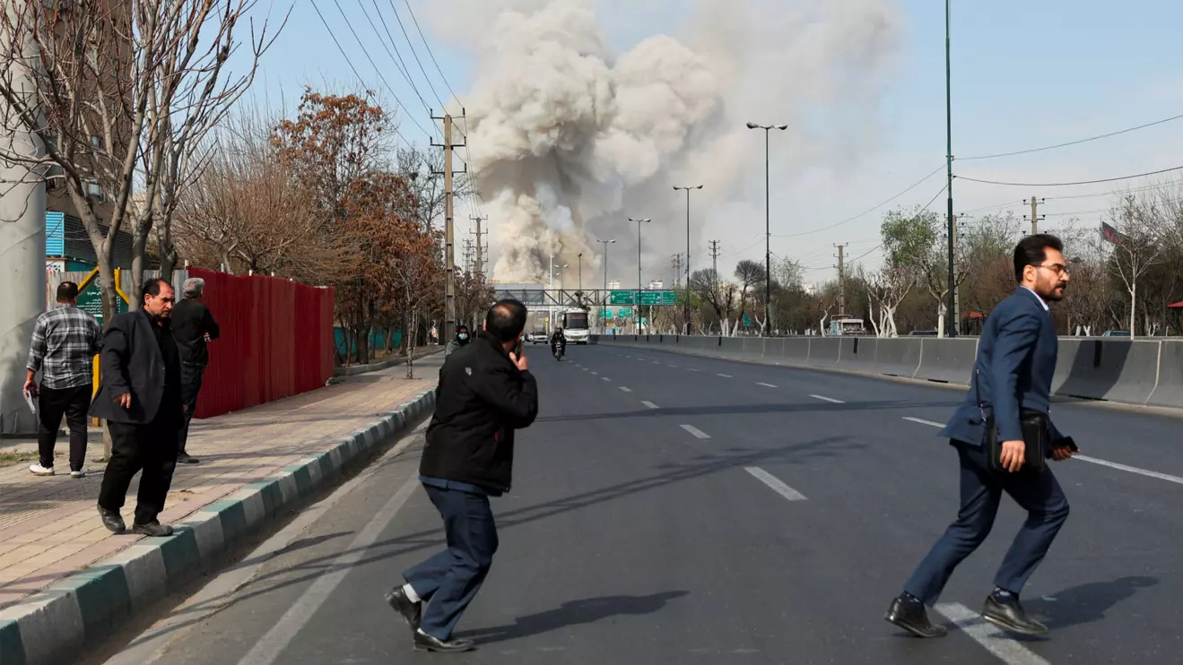 People run as smoke rises following an explosion, amid the U.S.-Israeli conflict with Iran, in Tehran, Iran, March 5, 2026. Majid Asgaripour/WANA (West Asia News Agency) via Reuters