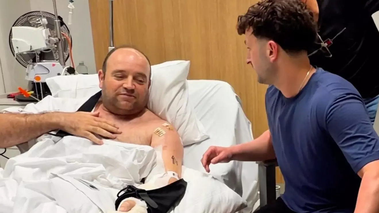 Influencer Zachery Dereniowski gives a check of 2,533,585 dollars to Ahmed al Ahmed, the bystander who is hailed as the "Bondi hero" after he charged at one of the gunmen and seized his rifle during the deadly shooting at Bondi Beach, in Sydney, Australia in this screengrab taken from social media video released December 19, 2025. @mdmotivator via TikTok