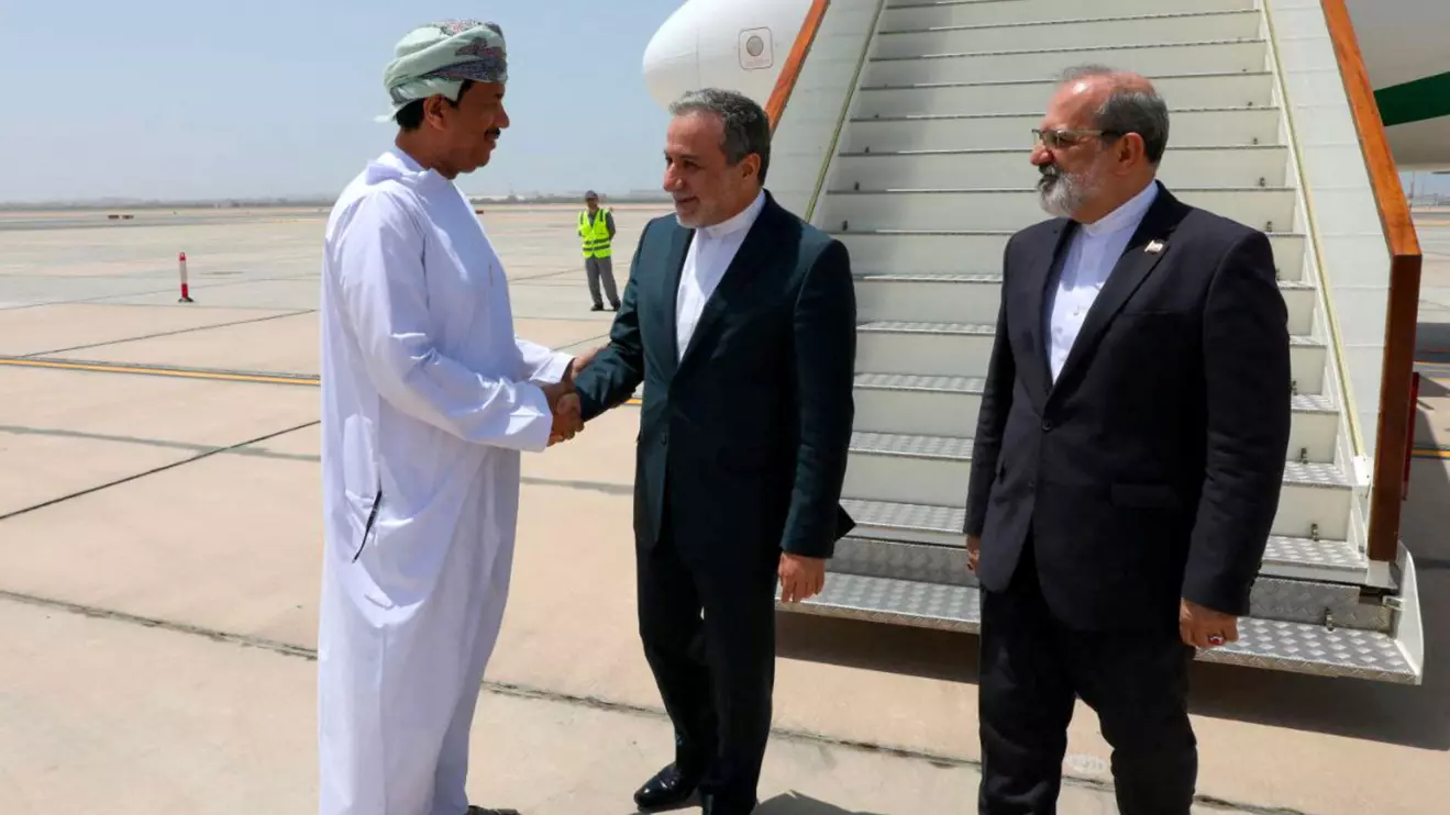 Iran's Foreign Minister Abbas Araghchi is welcomed by an unidentified Omani official upon his arrival in Muscat, Oman, May 11, 2025. Iranian Foreign Ministry/WANA (West Asia News Agency)/Handout via Reuters