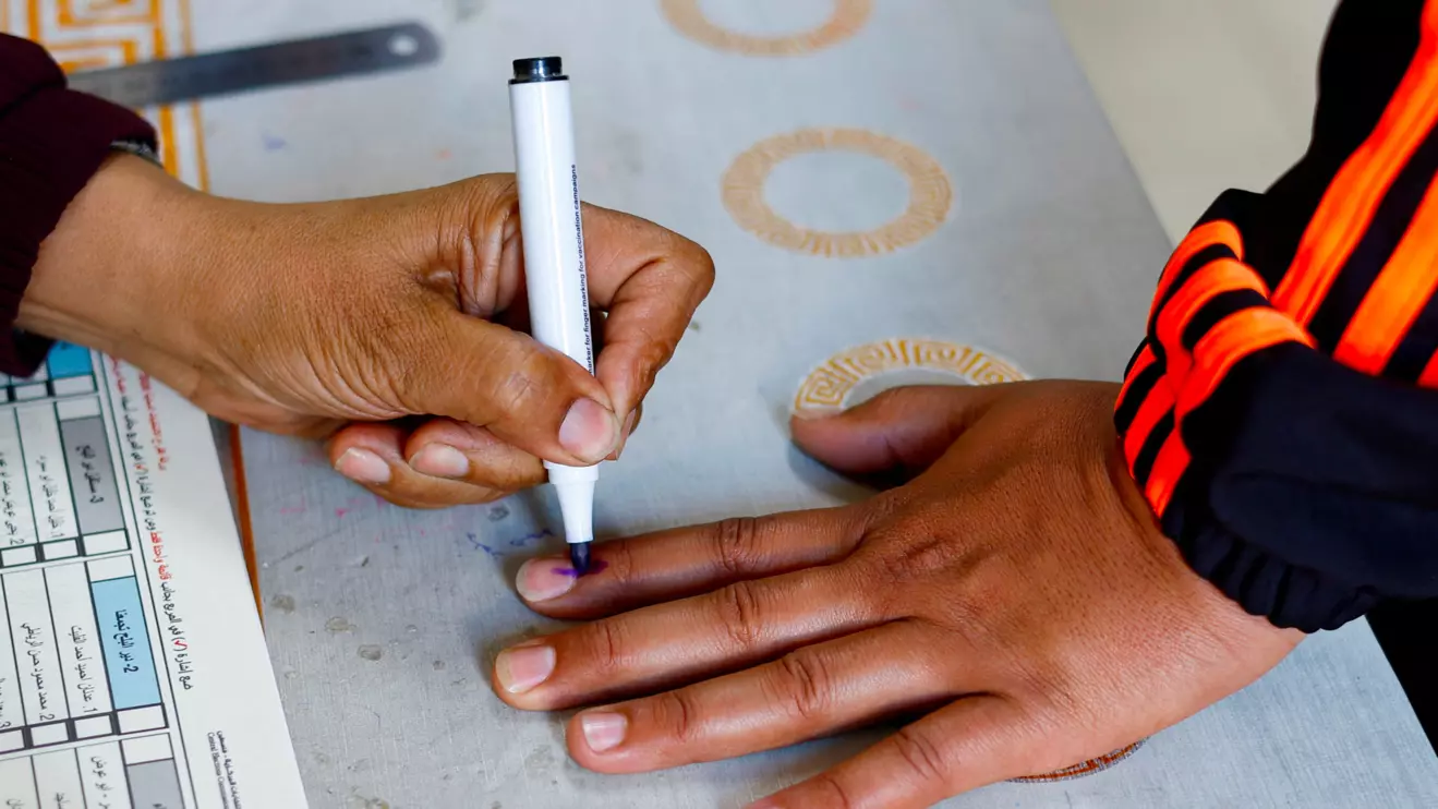 A polling official marks the finger of a Palestinian voter with ink during the municipal election at a polling station in Deir al-Balah, central Gaza Strip April 25, 2026. Reuters/Mahmoud Issa