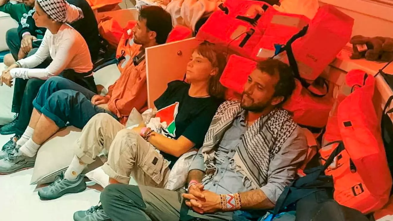 Swedish activist Greta Thunberg and Brazilian activist Thiago Avila sit in a vessel making their way to Israel, after Israel intercepted some of the vessels of the Global Sumud Flotilla aiming to reach Gaza and break Israel's naval blockade, in this handout image released on October 2, 2025 © MFA IL 