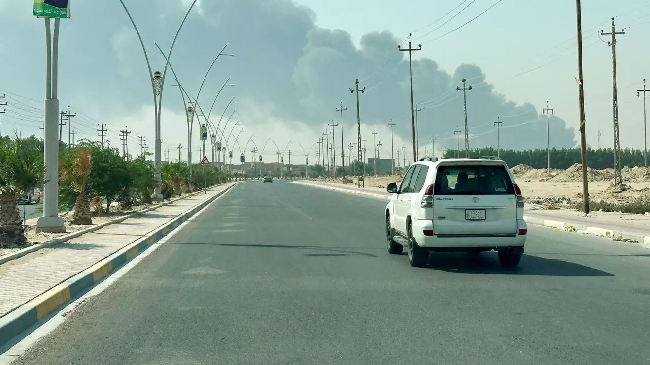 Smoke rises from a fire at an oil pipeline in Iraq's Zubair oilfield, as seen through a car window, near Basra, Iraq October 26, 2025. Reuters/Mohammed Aty