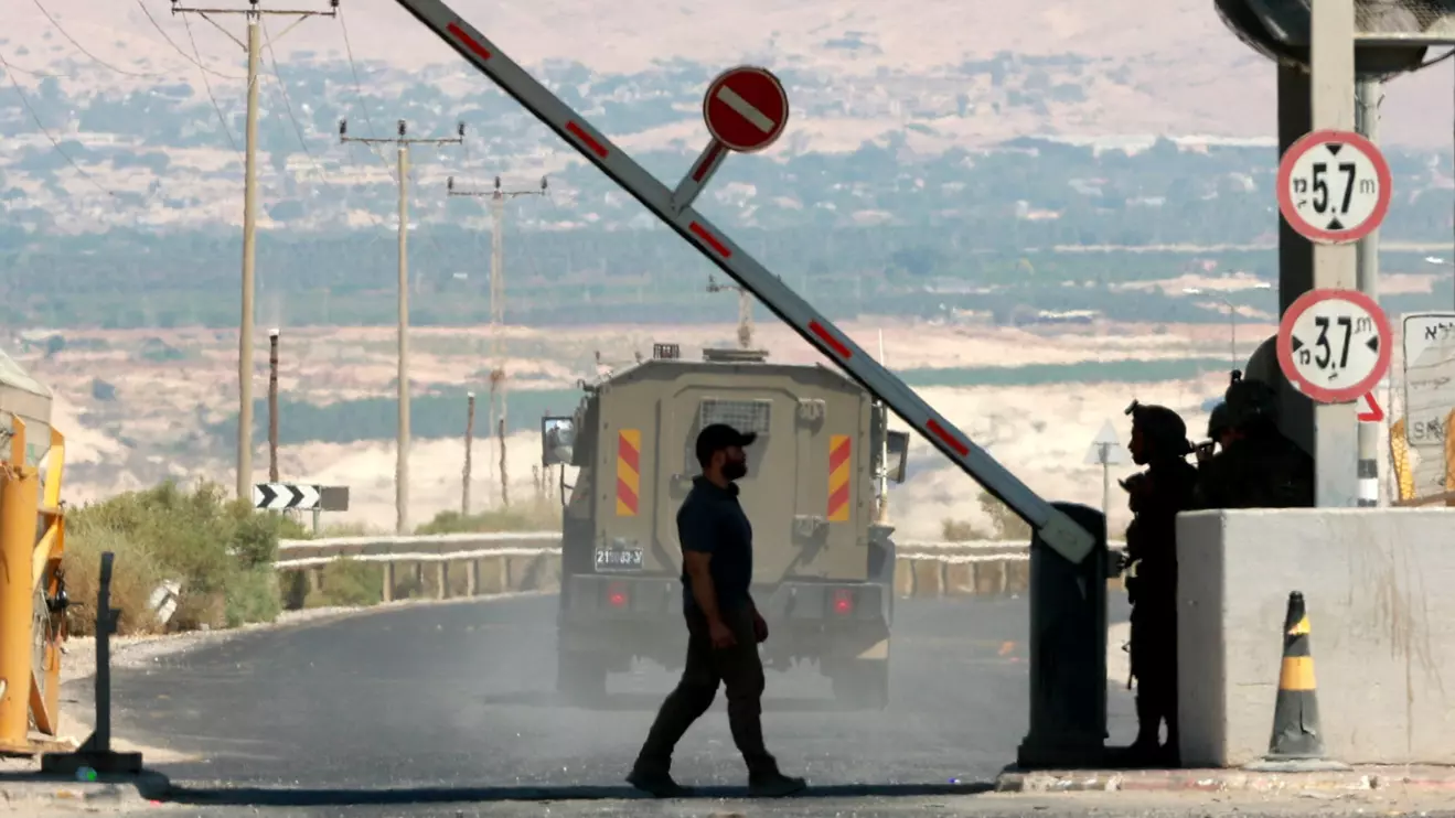 A man walks at a barrier, at the Allenby Bridge Crossing between the West Bank and Jordan, September 8, 2024. Reuters/Ammar Awad