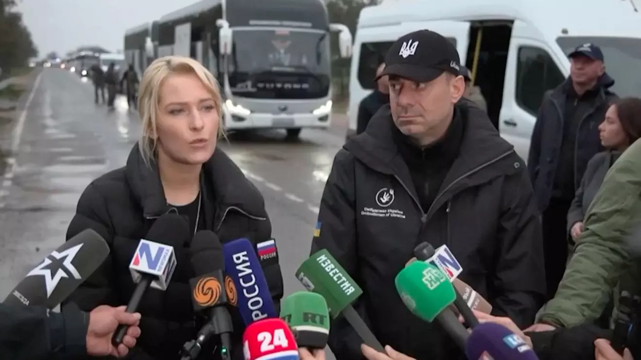 Russia's human rights commissioner Yana Lantratova and Ukraine's human rights ombudsman Dmytro Lubinets speak with journalists on a road in front of an aid convoy, said to be poised to drive towards the town of Oleshky, at a location given as the Kherson region, a Russian-controlled area of Ukraine, October 30, 2026, in this still image taken from video. Human Rights Commissioner Yana Lantratova/Handout via Reuters
