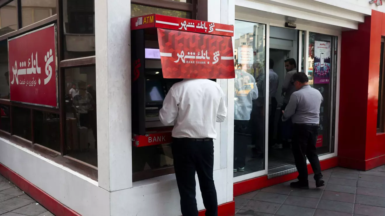 A man uses an ATM in front of a bank in Tehran, Iran, August 17, 2026. Majid Asgaripour/WANA (West Asia News Agency) via Reuters
