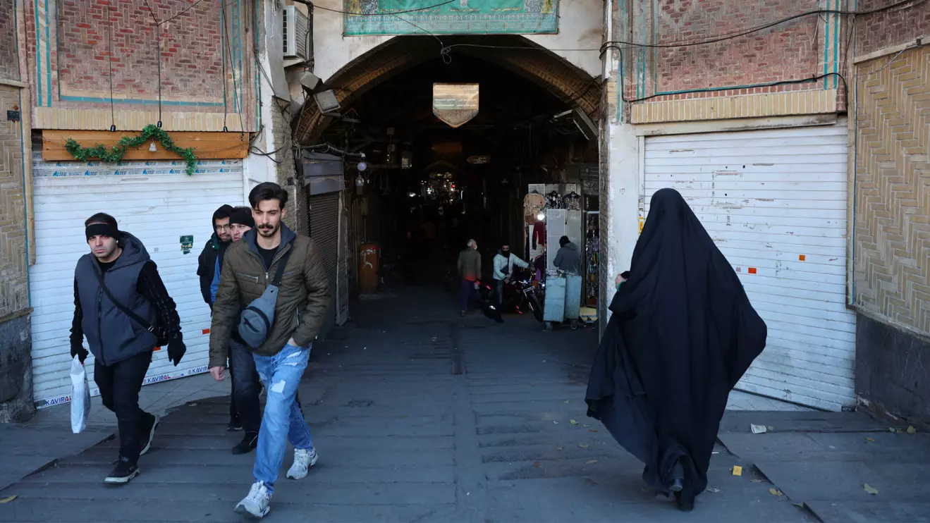 People walk past closed shops following protests over a plunge in the currency's value, in the Tehran Grand Bazaar in Tehran, Iran, December 30, 2025. Majid Asgaripour/WANA (West Asia News Agency) via Reuters