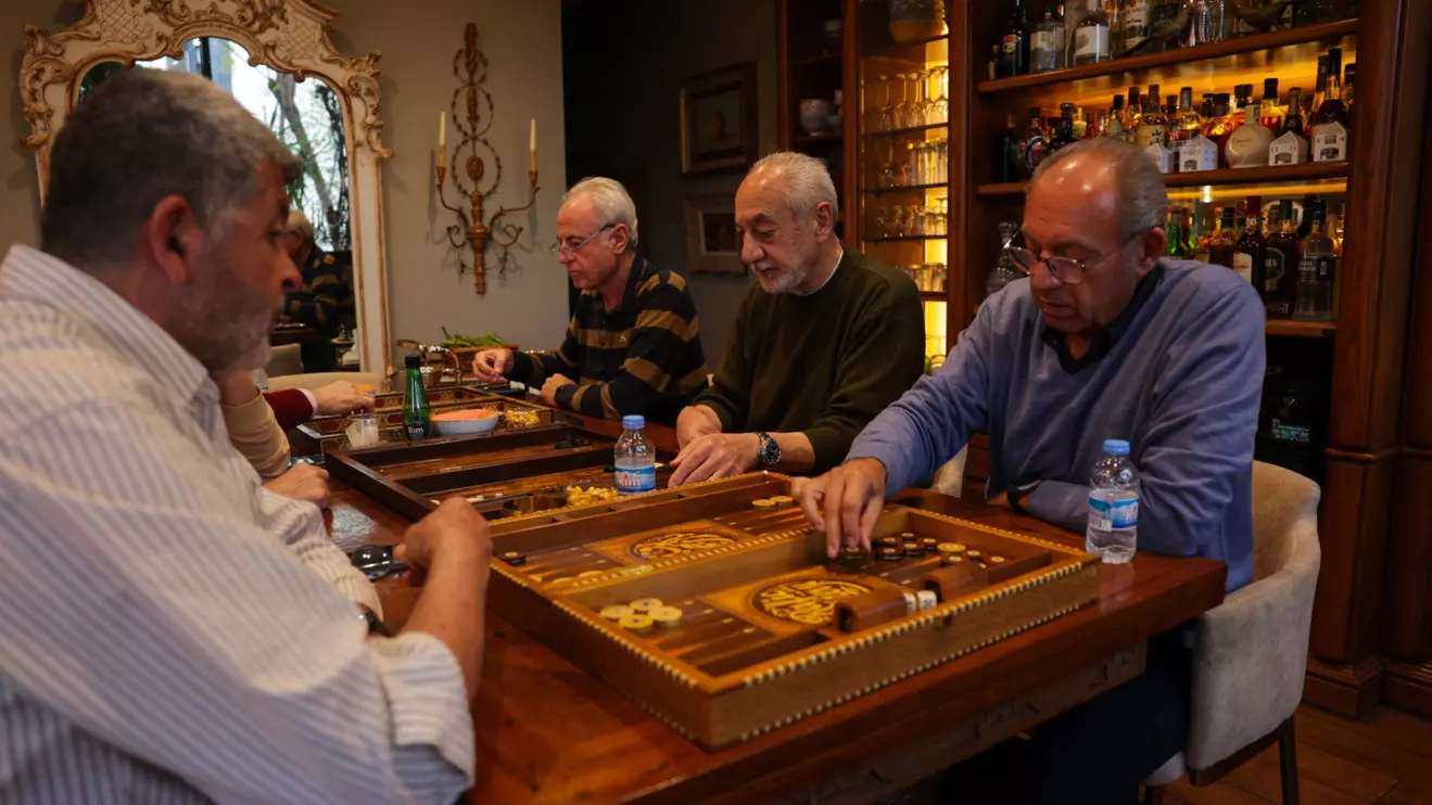 Rafic Bazerji, President of the Latin league and owner of Bouyouti guest house, plays backgammon with his friends in his home in Beirut, Lebanon, April 11, 2026. Reuters/Emilie Madi