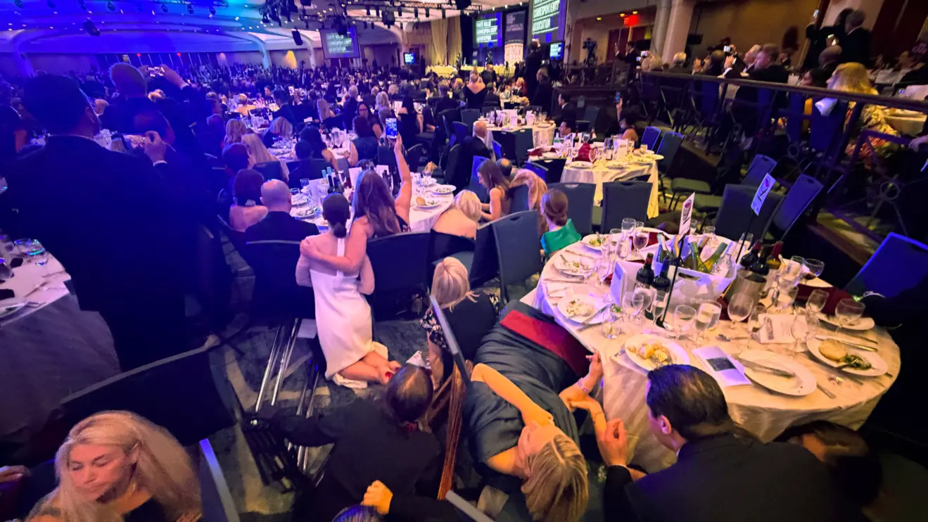 Guests take cover after U.S. President Donald Trump and first lady Melania Trump were rushed out of the White House Correspondents' Association dinner by Secret Service agents after a loud, unidentified noise, in Washington, D.C., U.S. April 25, 2026. Reuters/Evan Vucci