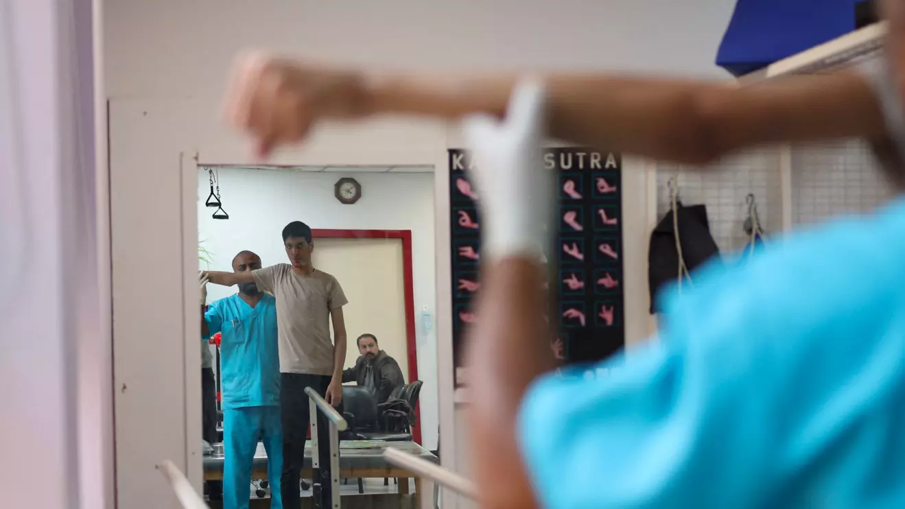 Palestinian student Karam Nwajaa, 17, who lost his mother, one brother and one sister during the war, undergoes physiotherapy with physiotherapist Khader Alhmaimat, 38, at the Reconstructive Surgery Hospital of the Doctors Without Borders (MSF) in Amman, Jordan, January 5, 2025. Reuters/Stelios Misinas