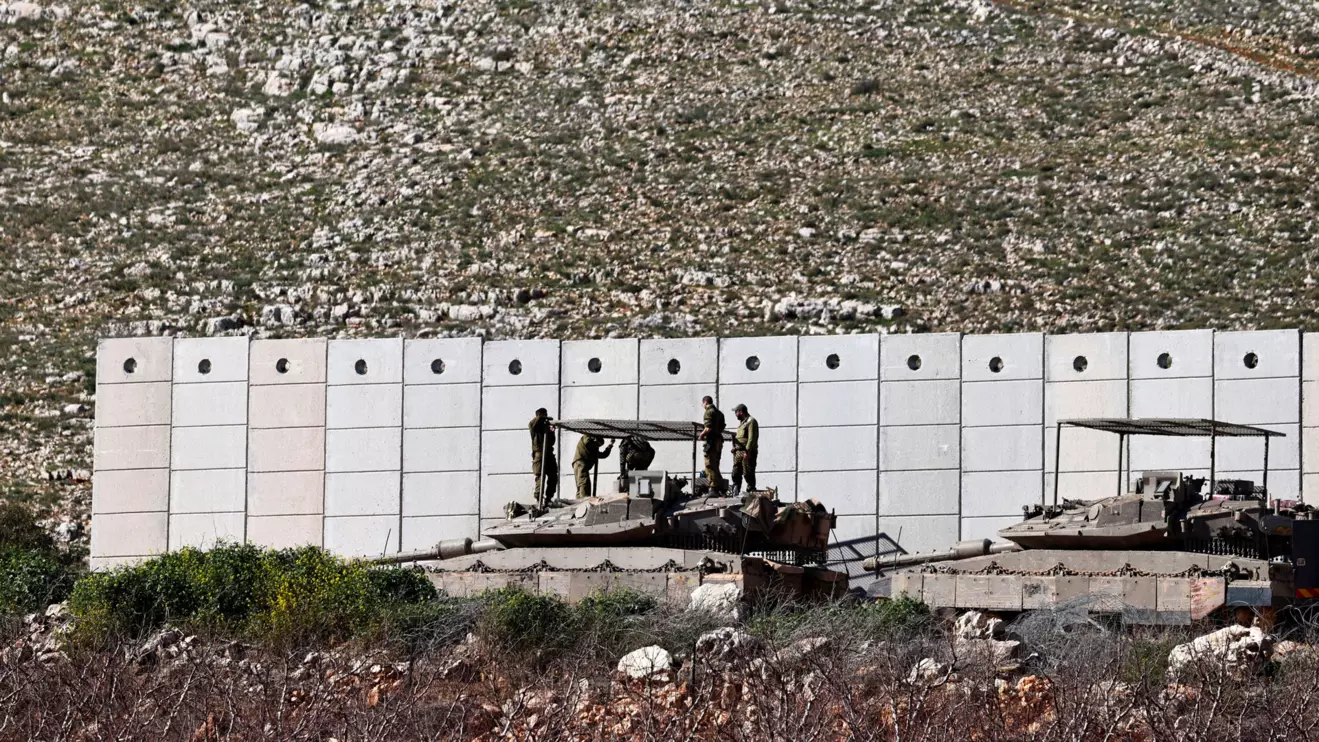 Israeli soldiers work on their tank on the Israeli side of the Israel-Lebanon border, amid escalation between Hezbollah and Israel, and amid the U.S.-Israeli conflict with Iran, in northern Israel, March 10, 2026. REUTERS/Amir Cohen
