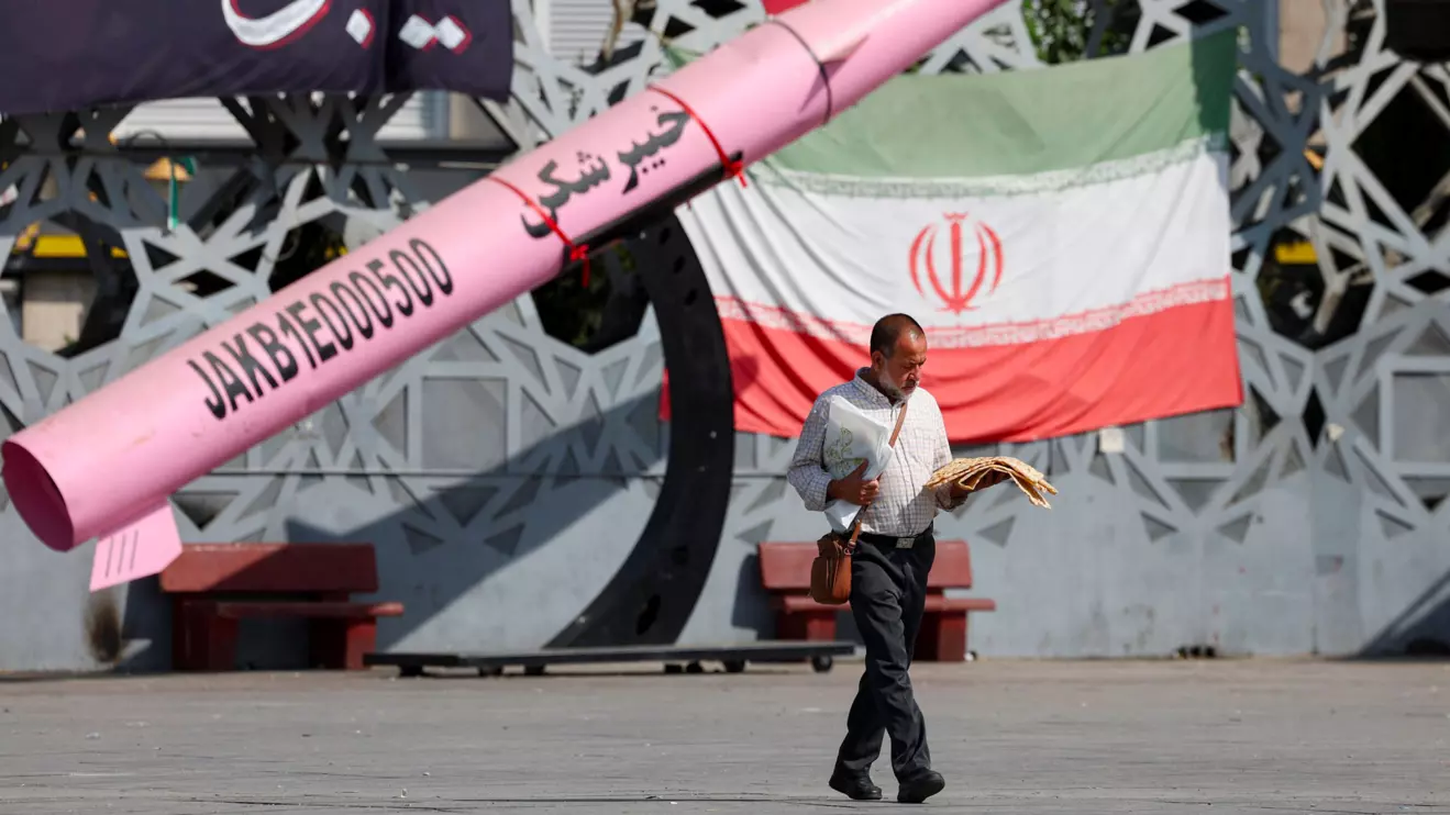 A man walks next to a symbolic mockup of an Iranian missile and an Iranian flag at Imam Hussein Square in Tehran, Iran, July 12, 2026. Majid Asgaripour/WANA (West Asia News Agency) via Reuters