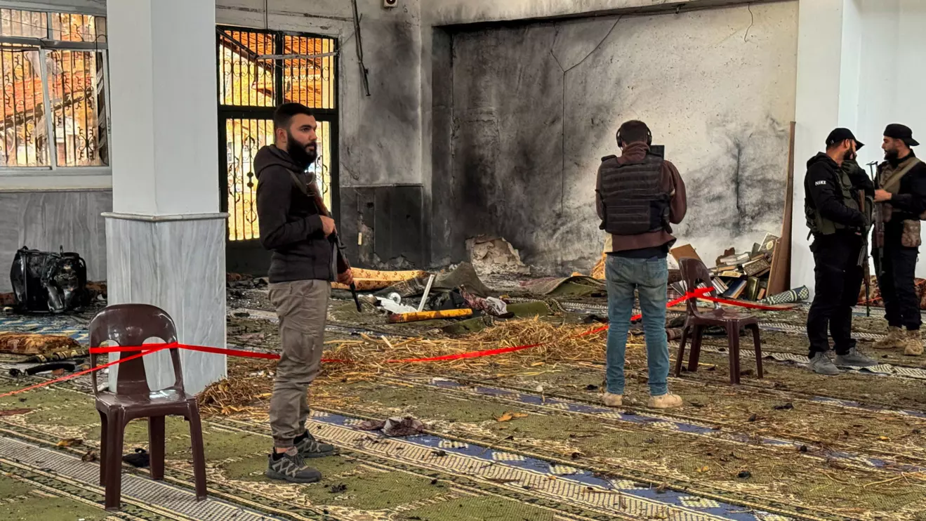 Syrian security forces stand inside a damaged mosque after several people were killed in an explosion at a mosque of the Alawite minority sect, as a Syrian Arab News Agency (SANA) said, in Homs, Syria December 26, 2025. Reuters/Ali Ahmed al-Najjar