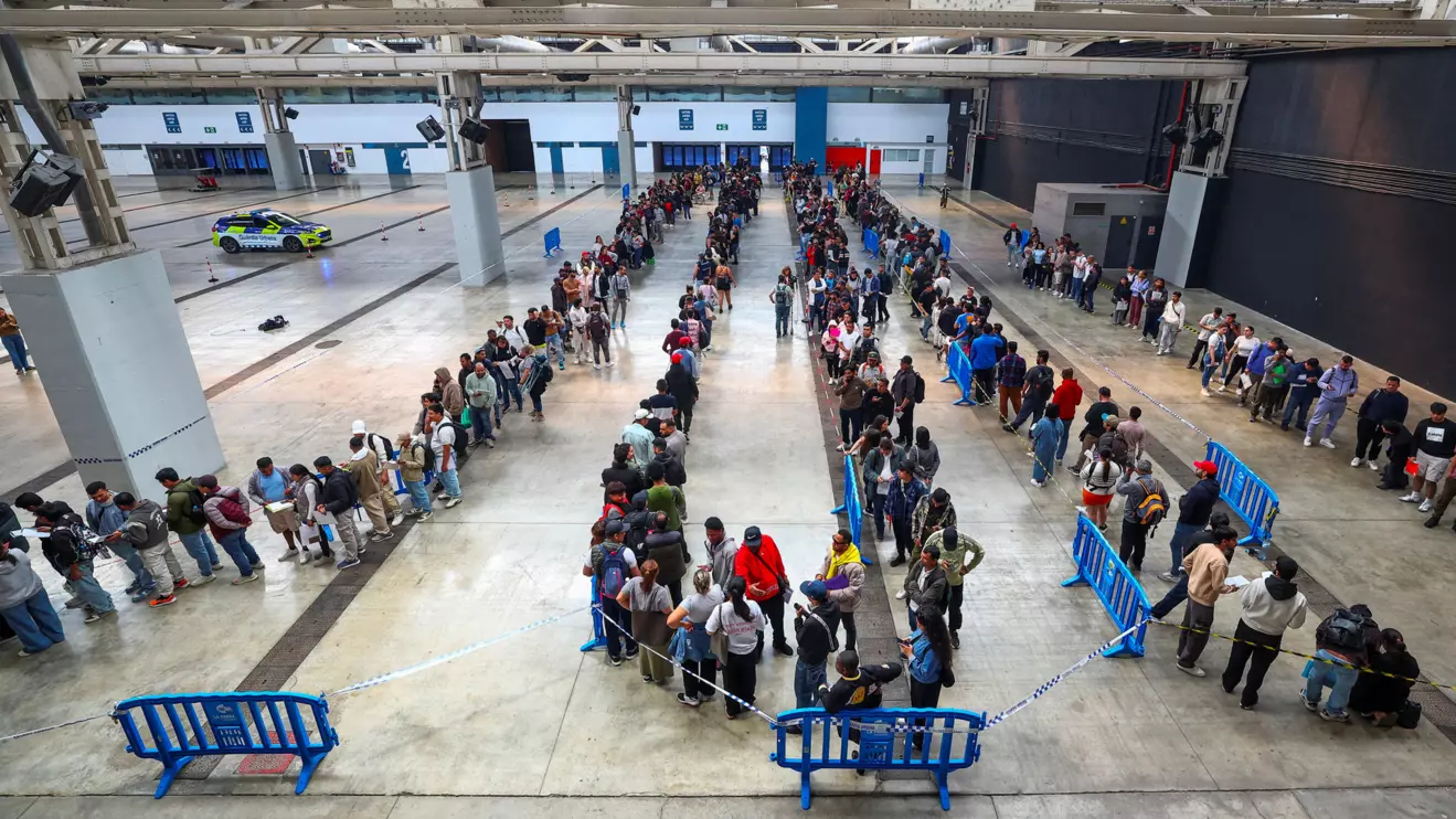 People queue to receive documentation as Spain's mass migrants regularisation process is set to start, in Hospitalet de Llobregat, near Barcelona, Spain, April 20, 2026. Reuters/Albert Gea